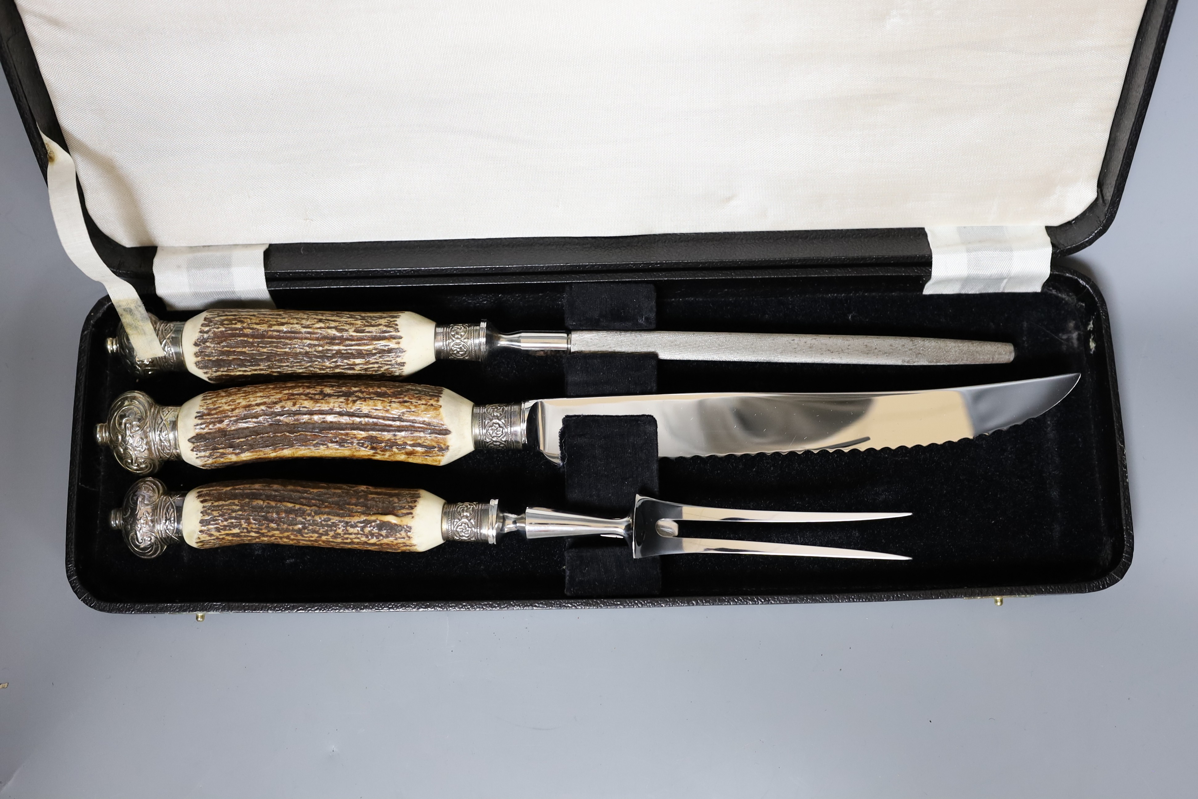 A Greenwood and Sons stag antler handled carving set, in original box